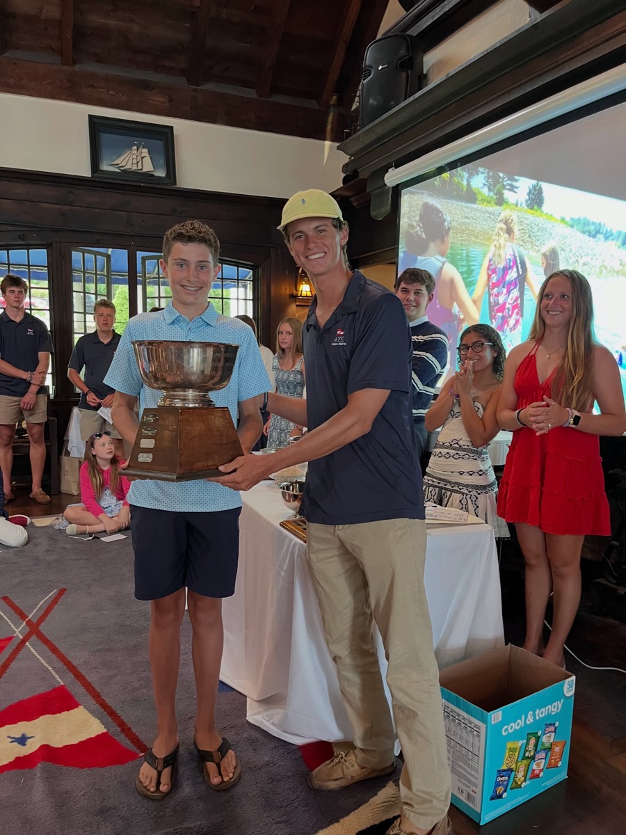 A junior sailor receiving a trophy at AYC’s end-of-season awards